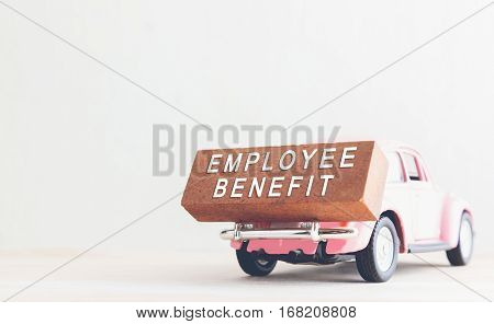 concept is text employee benefits on the wood with car