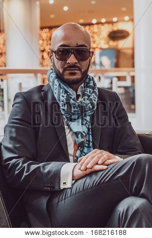 Arab businessman sitting on a sofa in an expensive hotel
