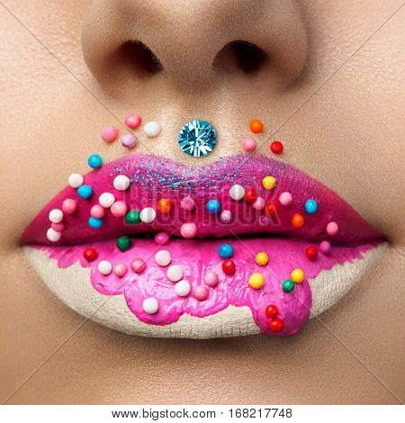 Close up view of female lips with sweet donut makeup. Fashion make up dessert or junk food concept. Macro studio shot