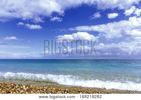 Beautiful sea paradise beach on a background of blue sky with clouds.