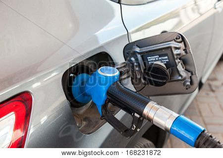 MOSCOW RUSSIA - AUGUST 6 2016: Fuel nozzle to release fuel into passenger car at gas station