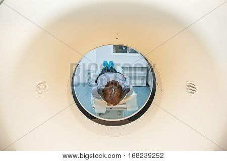 Close Up Patient At Ct Scan Tomography In Hospital, Shot Through The Tube Of Device. Selective Focus