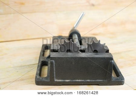 The vise to clamp on a wooden desktop environment tools.