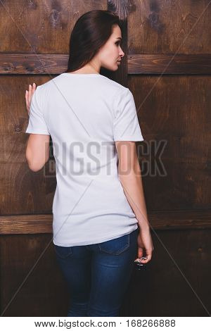 Young woman wearing blank white t-shirt with area for your logo or design, mock-up of template white t-shirt, back view