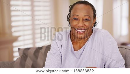 An Older Black Woman Happily Looks At The Camera