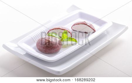 Chocolate coconut mochi ice cream on white background