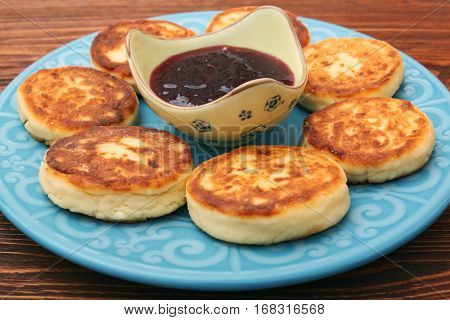 Beautiful golden cheese pancakes fried in a pan. Cottage cheese pancakes.