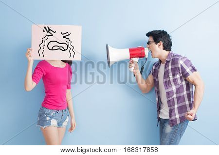 man take the microphone shout to woman angrily isolated on blue background