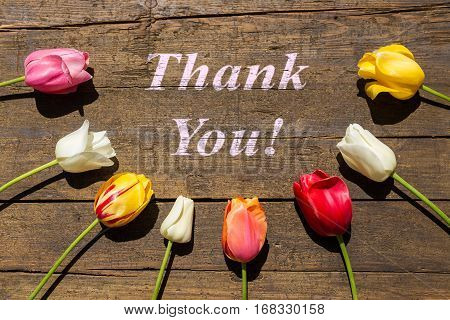 Greeting Card With Tulips On Wooden Table With Words Thank You