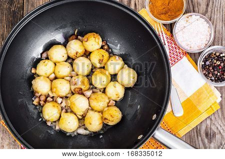 Fried potato dumplings with bacon in frying pan. Studio Photo