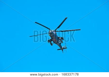 Black shark - militarian helicopter maneuver on blue sky