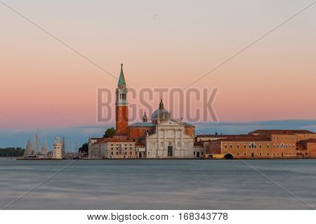 San Giorgio Maggiore church in Venice during beautiful  sunset with blurry Grand canal