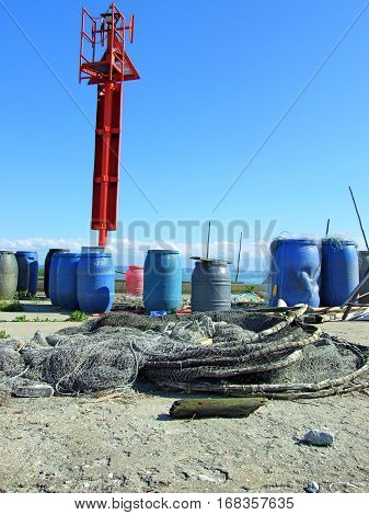 Fishnets and blue barrels on the wharf. The Vistula's Sandbar, Poland. June, 2016.