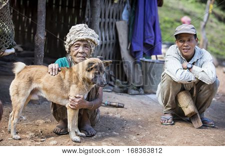 Chin region Myanmar November 11 2014: muun tribe chin lady with her dog