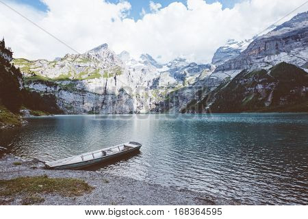 Glacier pond Oeschinensee. Popular tourist attraction. Picturesque and gorgeous scene. Location Swiss alps, Kandersteg, Bernese Oberland, Europe. Vintage effect. Instagram filtered. Beauty world.