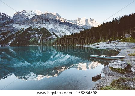 Glacier pond Oeschinensee. Popular tourist attraction. Picturesque and gorgeous scene. Location Swiss alps, Kandersteg, Bernese Oberland, Europe. Vintage effect. Instagram filtered. Beauty world.