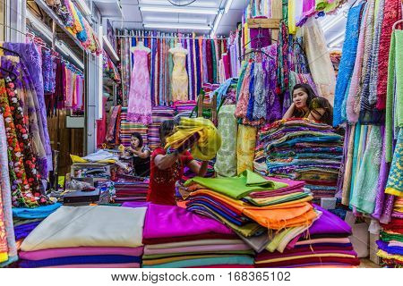 Yangon, Myanmar -November 25, 2016 : women in a cloth shops stall of Bogyoke Aung San Market Yangon in Myanmar