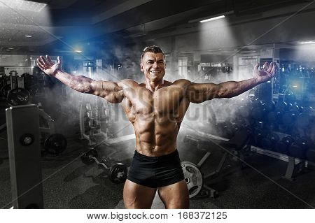Portrait Of A Handsome Muscular Bodybuilder Posing In Gym