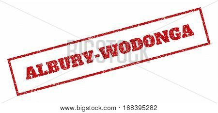 Red rubber seal stamp with Albury-Wodonga text. Vector message inside rectangular frame. Grunge design and dust texture for watermark labels. Inclined sign.