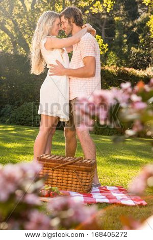 Happy couple having a picnic and embracing in the garden