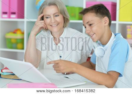 Portrait of a granny with her grandson using laptop