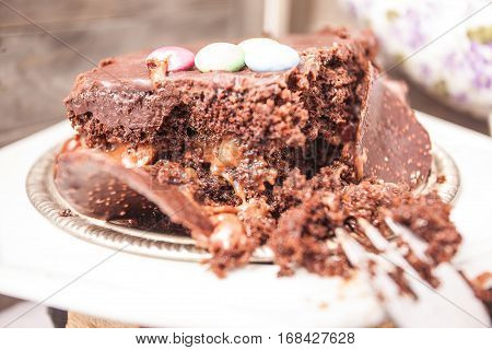 Slices of chocolate cake with strawberries. blueberries cream ganache hazelnut cream nuts cookies.