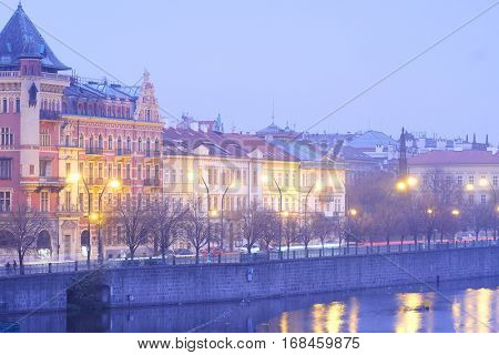 Prague, Czechia - November, 21, 2016: Panorama of an old Prague, bridges and embankment of Vitava river in an evening, Czechia