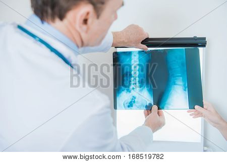 Xray Images Doctor Diagnosis. Medical Doctor and Practitioner Checking on Freshly Made Xray Images.
