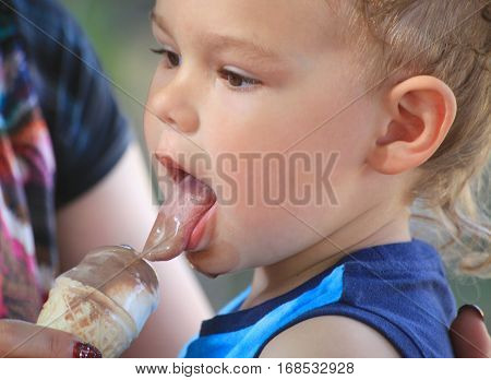 Casual portrait of a cute toddler with an ice cream cone.