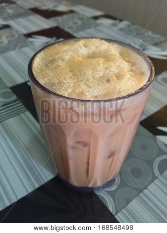 Top angle of teh tarik or milk tea.Its name is derived from the pouring process of 