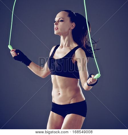 Full length view of an attractive woman with jumping rope