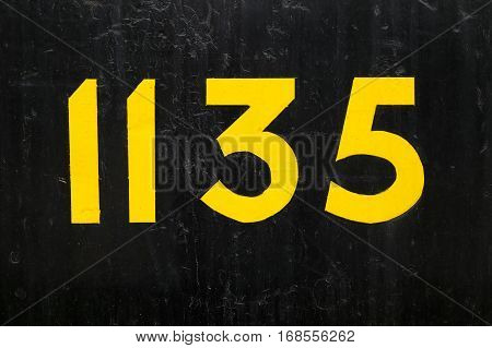 Close-up of the number 1135 on black.