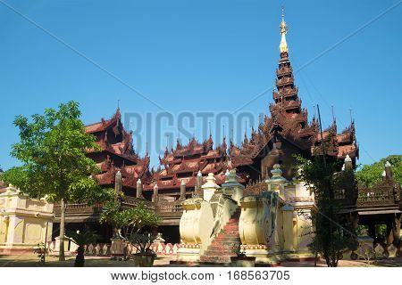 Old pagoda teak wood of Shwe In Bin Kyaung monastery a sunny day. Mandalay, Myanmar