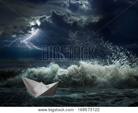 paper boat in ocean storm with lgihting and waves