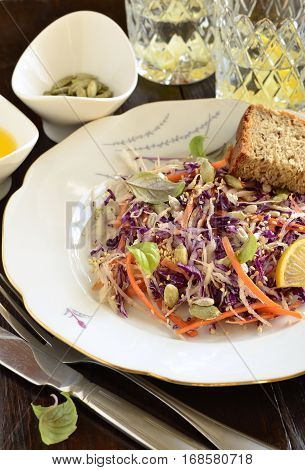 Salad with cabbage carrots and pumpkin sunflower sesame seeds Cole Slaw, vertical