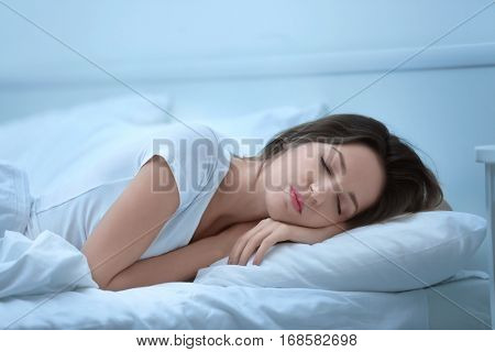 Young attractive woman sleeping in bed at home