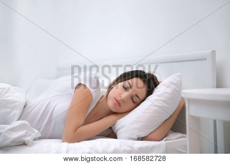 Young attractive woman sleeping in bed at home