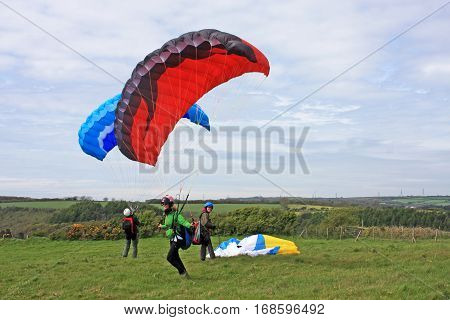 Paragliders preparing to launch their paraglide wings