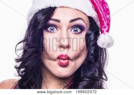 Girl in a hat santa claus pulls lips