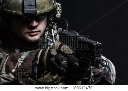 United states Marine Corps special operations command Marsoc raider with pistol. Studio shot of Marine Special Operator black background