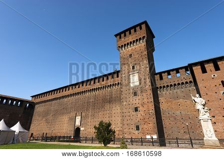 Sforza Castle XV century (Castello Sforzesco) in Milan Lombardy Italy with Tower of Bona and Giovia and statue of St. Giovanni Nepomuceno Bohemian priest
