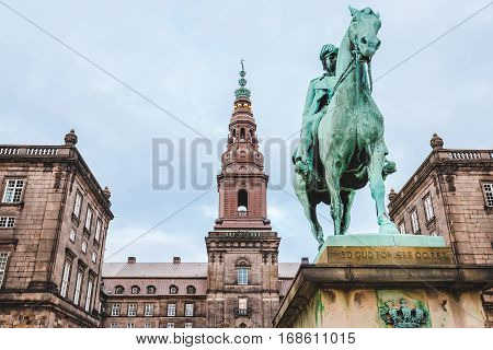 Christiansborg palace and King Christian IX statue in Copenhagen, Denmark. Famous landmark of danish capital. The seat of parliament on Slotsholmen.