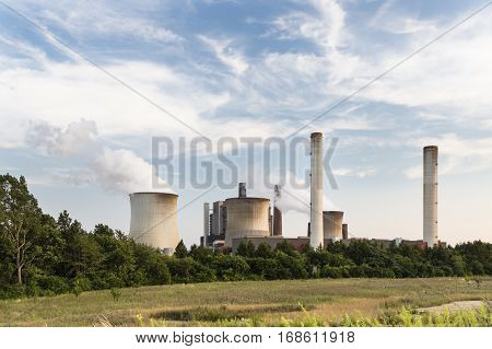 Power Plant Behind Field And Trees