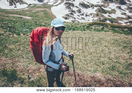 Woman traveling with backpack hiking in mountains Travel Lifestyle success concept adventure active summer vacations outdoor mountaineering sport
