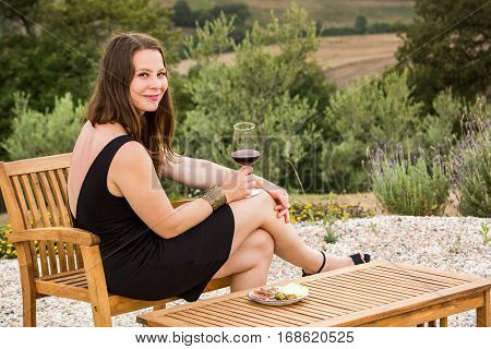 Girl With A Glas Of Wine At Sunset In Tuscany, Italy
