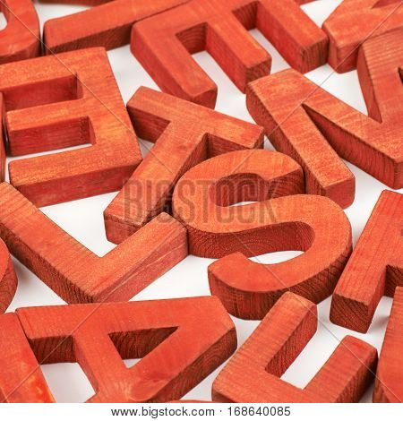 Surface coated with the multiple painted wooden block letters as an abstract backrop composition