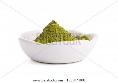 Green Tea powder on the plate on white background