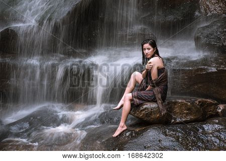 Asian sexy woman bathing in cascade Thailand