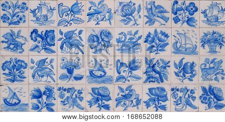 Typical old Portuguese tiles with hand painted figures in blue over white