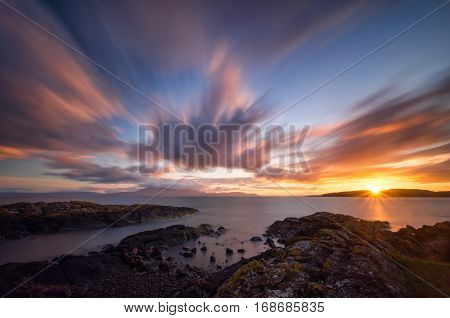 Ardneil Bay with distant Isle of Arran in colorful sunset Highlands Scotland
